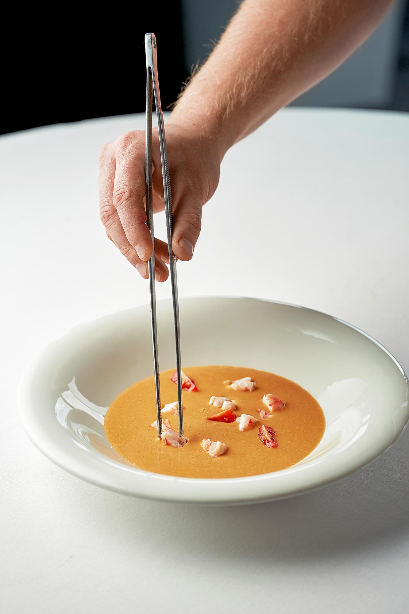 detail of hands finishing a sauce